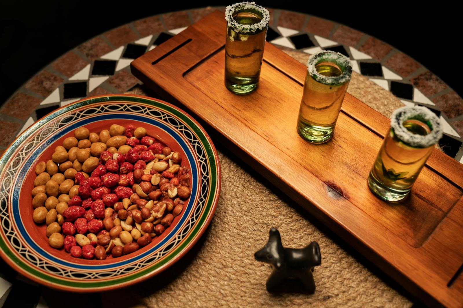 Glasses with Tequila and Nuts on the Plate